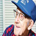 Bob Wissman wearing glasses and a blue hat.